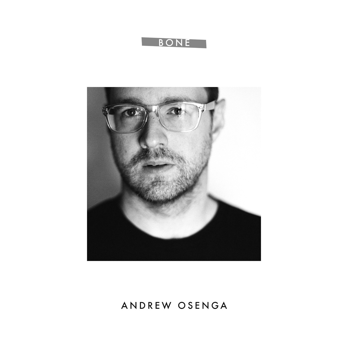 Album Art of Andrew Osenga's Bone EP - On a white background, the middle 25% of the artwork is a photo of a white man's face looking into the camera with a bit of a neutral expression and a slightly open mouth. Above, in the white space, a grey color rectangle has the words 'Bone' printed in uppercase white. Below the photo, in bigger font is the artist's name in black text.
