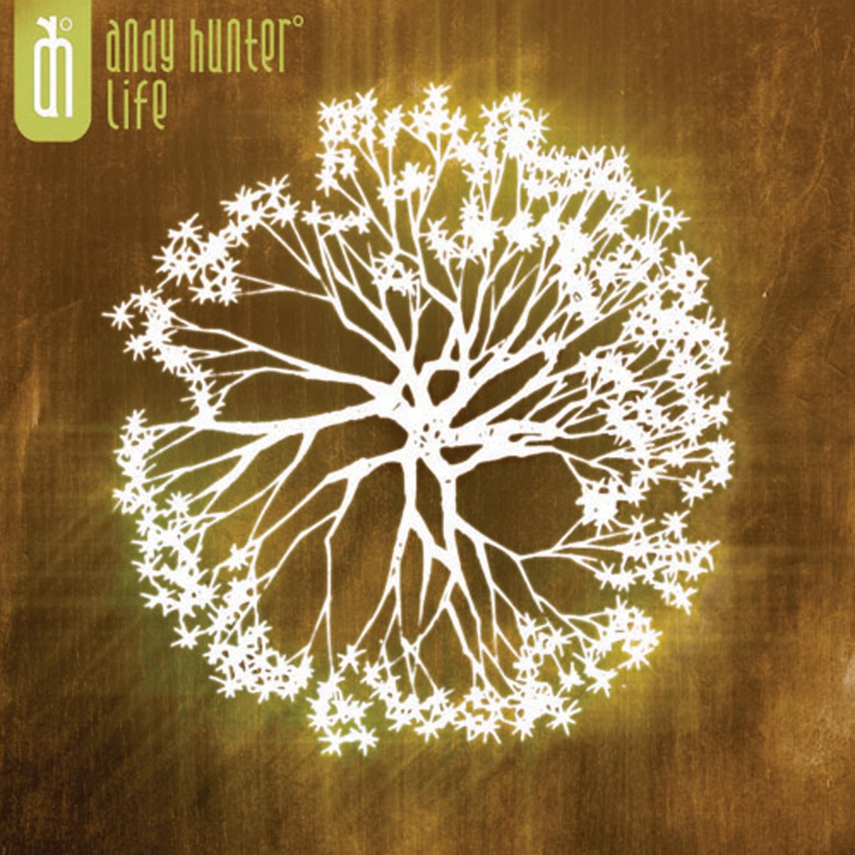 Album Art of Andy Hunter's Life album - On a brown, golden-ish background, a white circle that consists of white trunks in the middle emanating in all directions to some circular sprouts around the edge, forming the bigger circle. The white trunks/sprouts seem to be glowing a bit, as the background is a bit lighter around them. In the top right, the artist name and album cover is printed in s very tall, thin font on two lines, with the artist's 'ah' logo to its left.