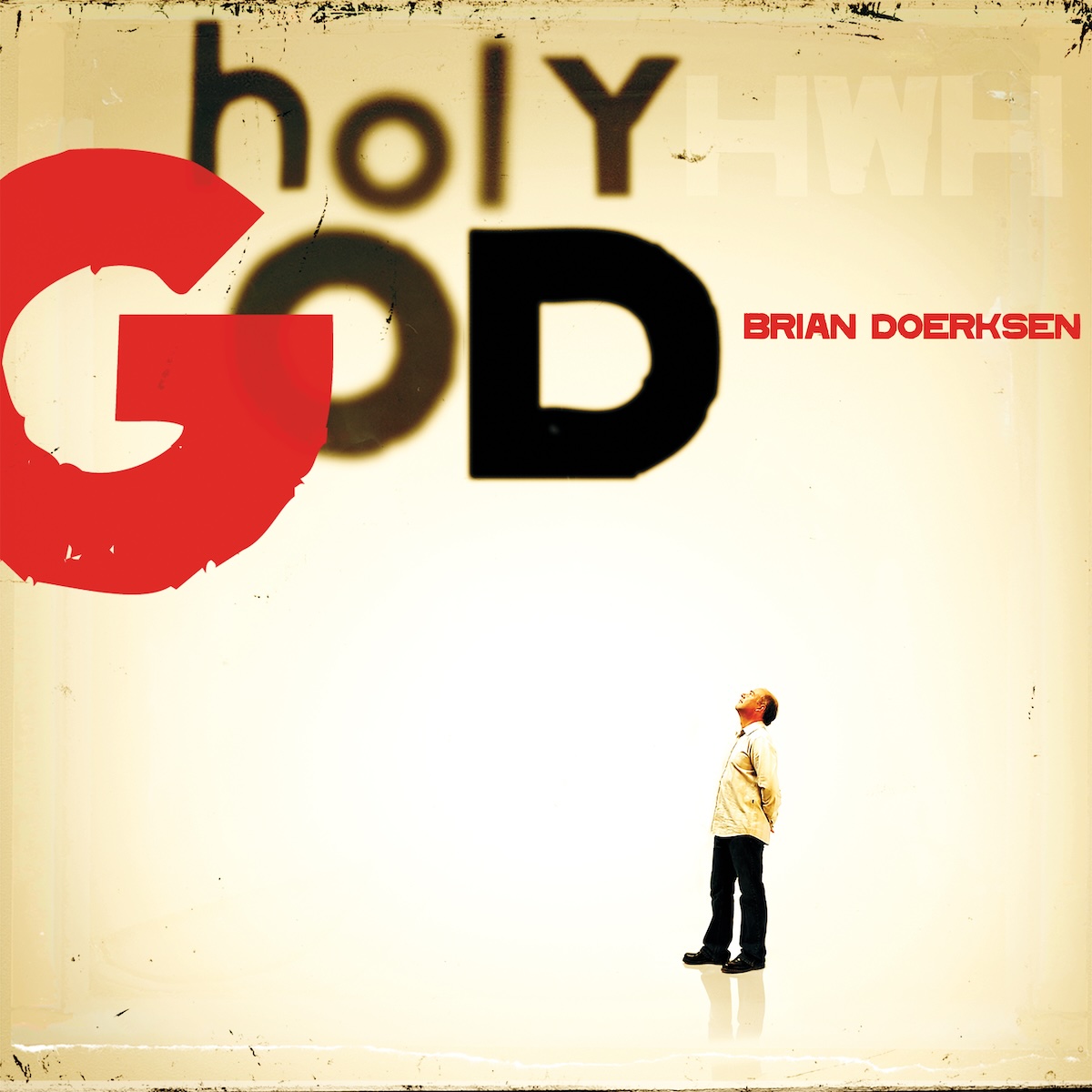Album Art of Brian Doerksen's Holy God album - On a white background with sepia-toned edges, a man stands on a shiny floor that matches the background. He's wearing a white shirt and black pants and is somewhat bald and is looking up to the words printed above him. He's rather small on the frame of the cover, smaller than the album title words 'Holy God' are above him. Some of the letters are a bit out of focus. Next to the 'Y' is the letters 'HWH' in very faint white, to spell 'Yhwh', another Hebrew name of God. In small red letters next to the word 'God' is the artist's name.
