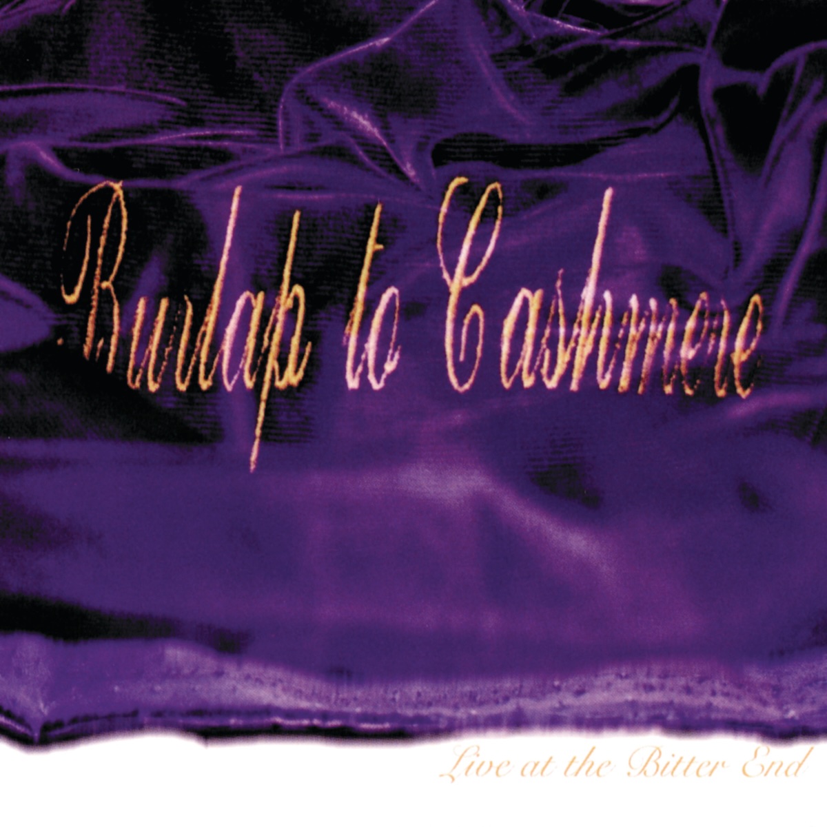 Album Art of Burlap To Cashmere's Live At The Bitter End EP - A purple fine cloth is spread out over a white background and on the purple cloth is printed in gold the band's name in a beautiful script font. Below the purple cloth is printed in a gold font the EP name in the white area.