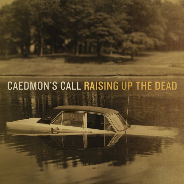 Album Art of Caedmon's Call's Raising Up The Dead album - A mostly de-saturated photo of a lake in the foreground with a wooded land beyond it. In the foreground is a classic four-door sedan vehicle half-submerged in the water. Across the middle, it has the band's name in white and the album name in gold right after it.