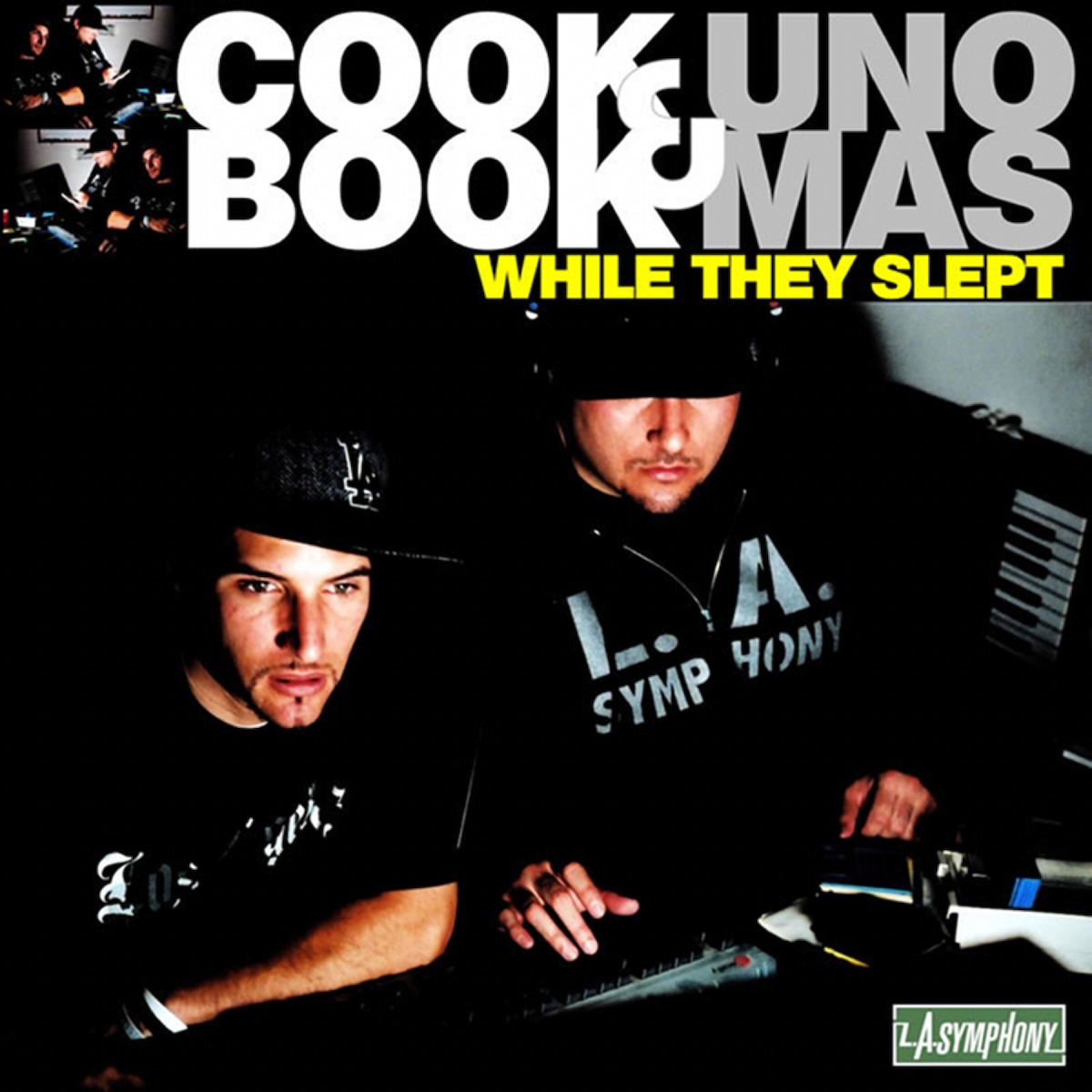 Album Art of Cookbook and Uno Mas's While They Slept album - A photo of two men in mostly black clothing and ball caps sitting in a dimly lit room with DJ equipment in front of them, a few turntables and faders, and a keyboard sitting propped up against the wall. They're photographed from above and are looking down below the camera. Across the top, it has the artist names in big print, `cookbook` split in two lines in white and 'uno mas' in two lines in grey to the right of it. Below that, in much smaller yellow text is the album title.