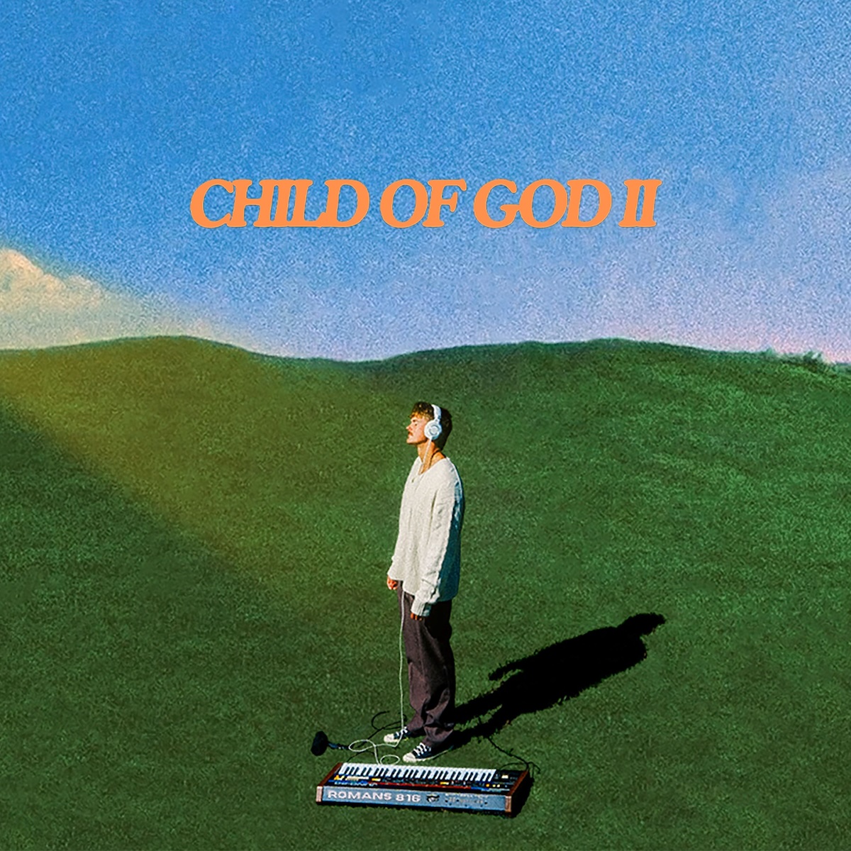 Album Art of Forrest Frank's Child Of God II album - A photo of a man standing in the bottom middle of a green field with a blue sky behind and a bit of clouds near the left side's horizon. The man has a shadow off to the right, is facing towards the sun on the left, and looks like has has his eyes closed. He's wearing headphones connected to a keyboard that's sitting on the ground near his feet. The image looks really pixelated and compressed; intentionally low quality.</body></html>