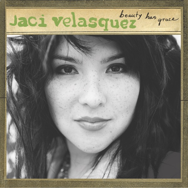 Album Art of Jaci Velasquez's Beauty Has Grace album - Around the edges, a brown paper frame. In the middle of it on the majority of it, a black-and-white photo for a young woman's face, with somewhat wild dark hair. Nothing much can be seen behind her because the photo is so close up. Above the photo is a golden brown strip that has the artist's name written in large, green letters in a handwritten-ish font, and then above that the album title off to the right in black cursive.