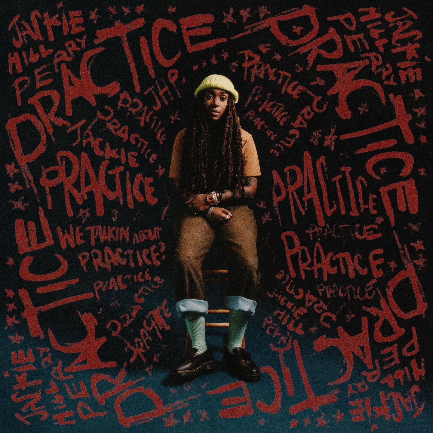 Album Art of Jackie Hill Perry's Practice EP - A black woman with long braided hair and wearing brown jeans and an orange-brown shirt plus a light green beanie is sitting on a wooden stool. Around here are painted the words 'Practice' and her name many times.
