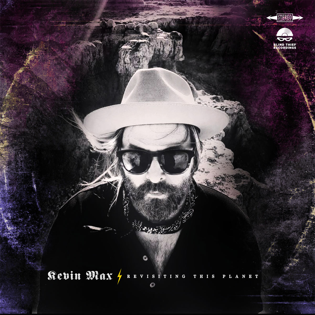 Album Art of Kevin Max's Revisiting This Planet album - A black and white photo of a white man in a trim beard wearing a black shirt and handkerchief around the neck is wearing sunglasses, a light-colored cowboy hat, and is standing on a rocky southern US landscape looking up at the camera. The cover has a purple hue on the edges and what looks like vinyl ringwear, where the record has been moved around so much that the case has been wearing out along the edges of the record.</body></html>