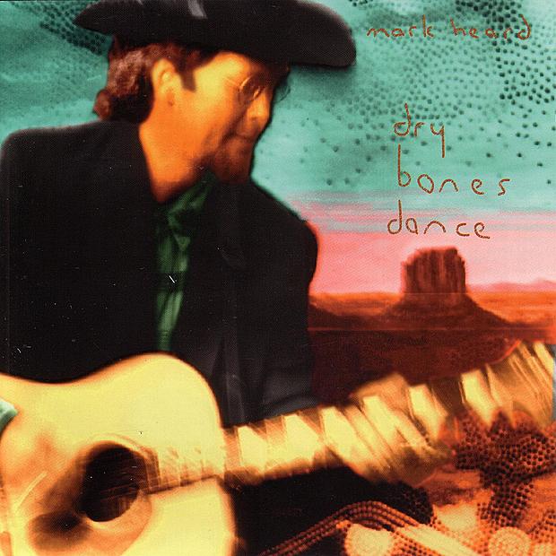 Album Art of Mark Heard's Dry Bones Dance original album artwork - Much like the original photo shown previously, this version has a more bright aqua blue sky. The handwritten artist name and title is more of a gold color and harder to make out.