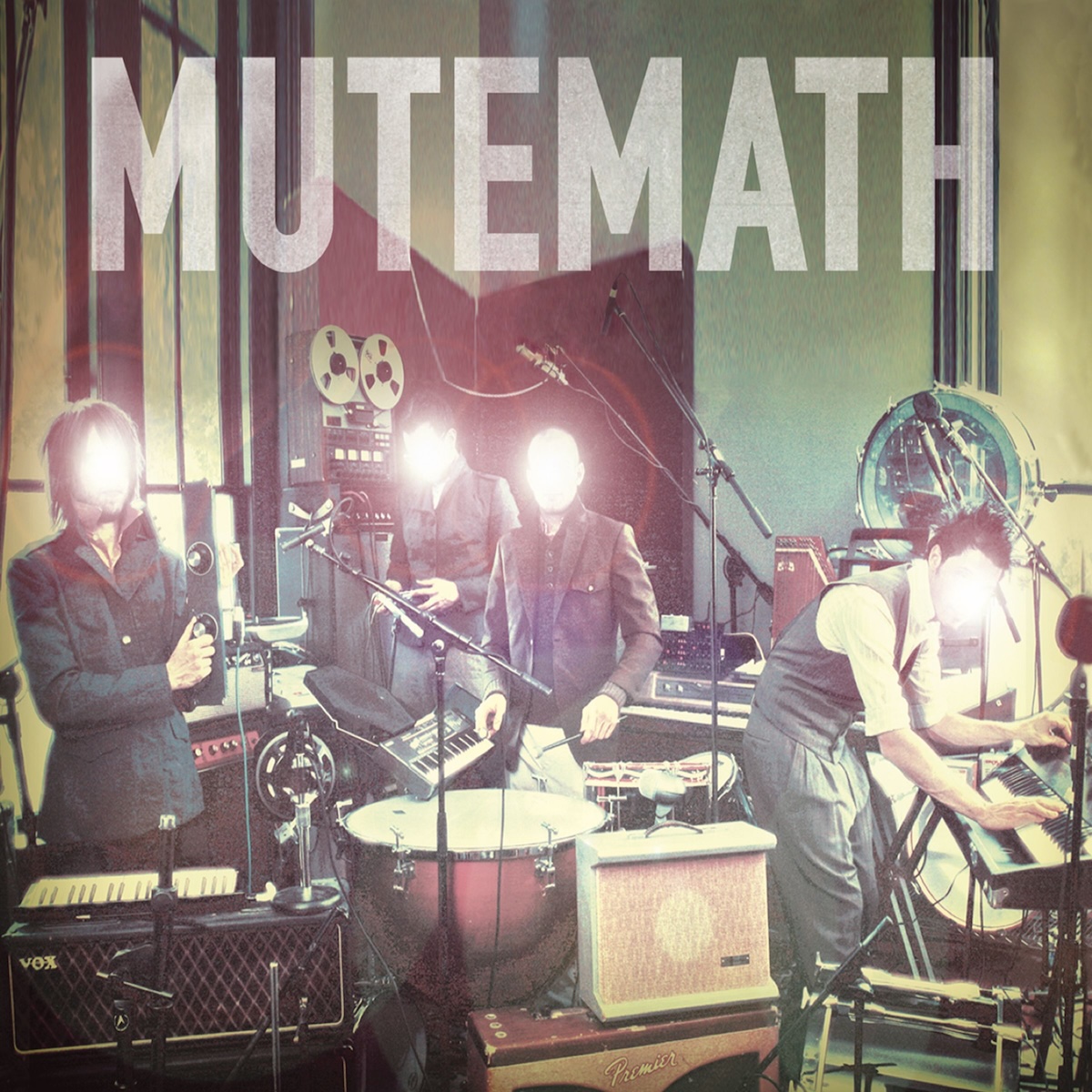 Album Art of Mutemath's self-titled album - A photo of four men in a small room amidst tons of drums, keyboards and other gear, somewhat in the midst of playing the gear but also looking at the camera, it seems. They are all wearing coats or vests and have short hair. A bright white light with maybe a bit of a red glow is emanating from where their faces should be, so their faces cannot be seen.</body></html>