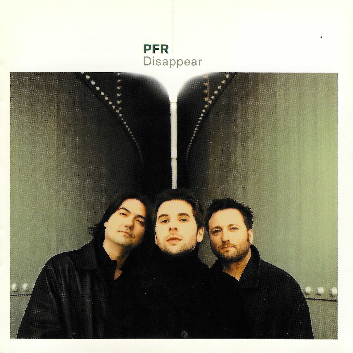 Album Art of PFR's Disappear album - On a creamy white background and border, the bottom three quarters is a color photo of three young men leaning into the middle of a camera frame and looking at the camera. They are flanked on both sides and stretching into the background by metal walls with a few lines of rivets, maybe like they're standing in between two large ship's hulls or something. The walls converge in the middle distance, and there's a bit of bright light there. Right above that point in the middle is printed the band's name in black and the album title in thinner gray print directly underneath the band name.