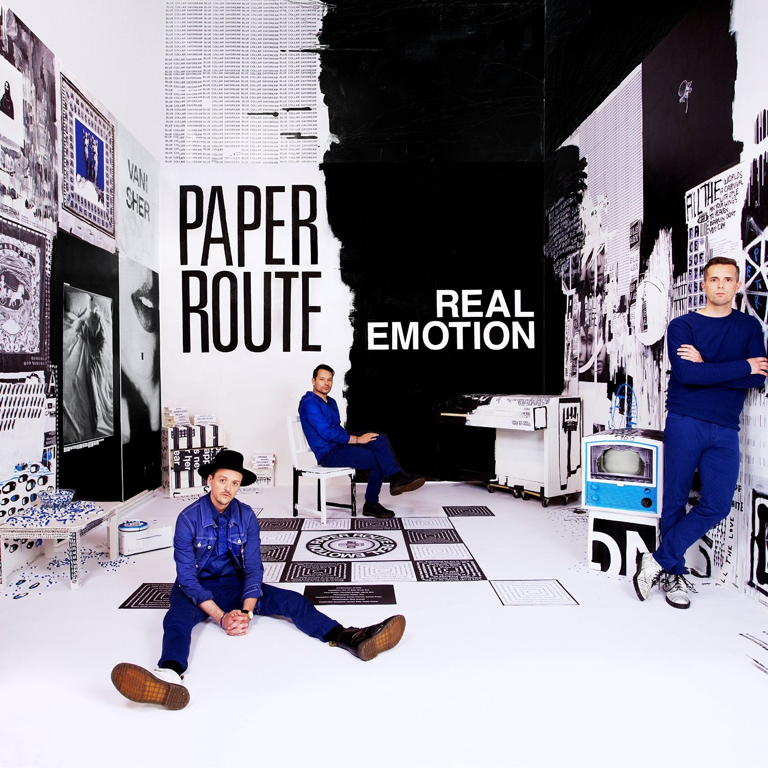 Album Art of Paper Route's Real Emotion album - A photo of what looks like a square room, although a closer look shows that the back wall keeps going up and there's no ceiling visible in the room. The left half of the back wall is white, and the right half is black, and the area where they meet is not a straight line, but more a haphazard edge. Next to the black wall is a piano, and half of it is also black and the other half white with an illustration painted on the side of it.</body></html>