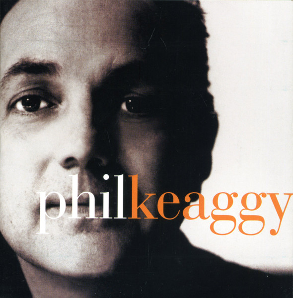 Album Art of Phil Keaggy's self-titled album - A black-and-white photo of a man lit from the left, only his face and neck, on the left of the frame. The background is white. The man is staring into the camera and has a blank look. Above his mouth is printed his first name in white, lowercase letters, with his last name in orange letters immediately after.