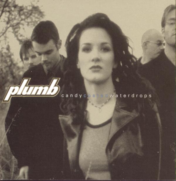 Album Art of Plumb's Candycoatedwaterdrops album - A photo of a dark-haired woman with a fitted tee and a leather jacket has four men behind her on the sides, half looking at the camera and half looking in other directions. They photo is black-and-white with the white parts being a gold-grey hue. Printed above the middle of the photo, to the left of the woman, is the band name in big, white letters. To the right of that, the album title in much smaller letter, with the letters 'coated' in a light blue.