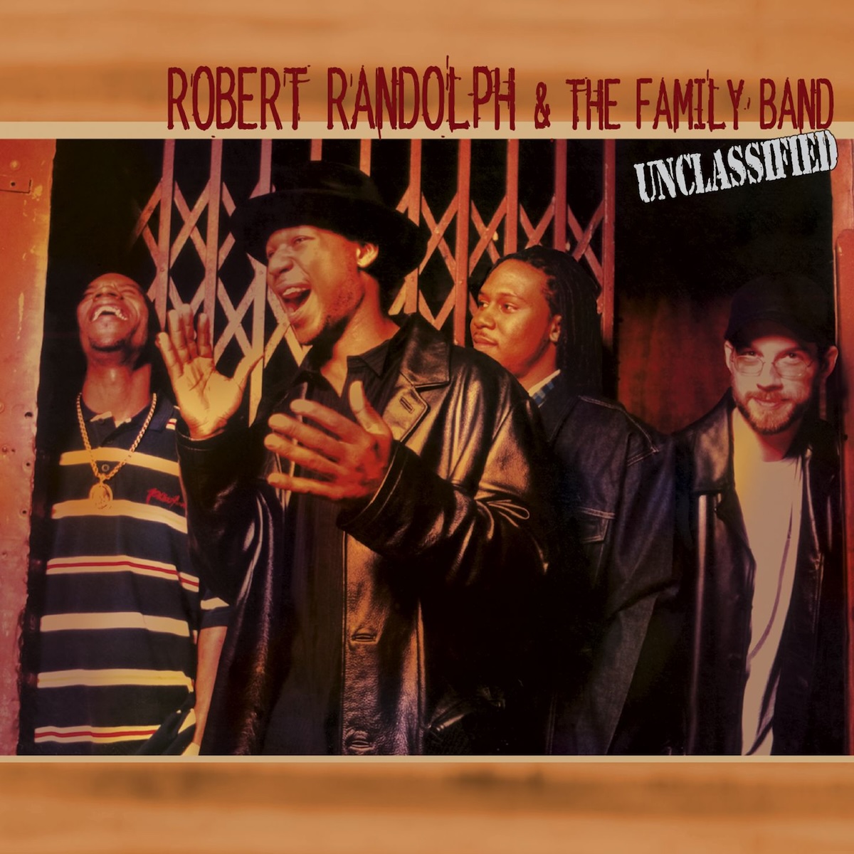 Album Art of Robert Randolph And The Family Band's Unclassified album - The top and bottom have a golden brown, blurry background. In the middle, a photo of four men standing in front of some sort of metal gate. The one in front is looking to the left side of the frame and clearly excited and exclaiming about something, with his hand about to clap together. He's also wearing a black leather jacket and a black brimmed hat.</body></html>