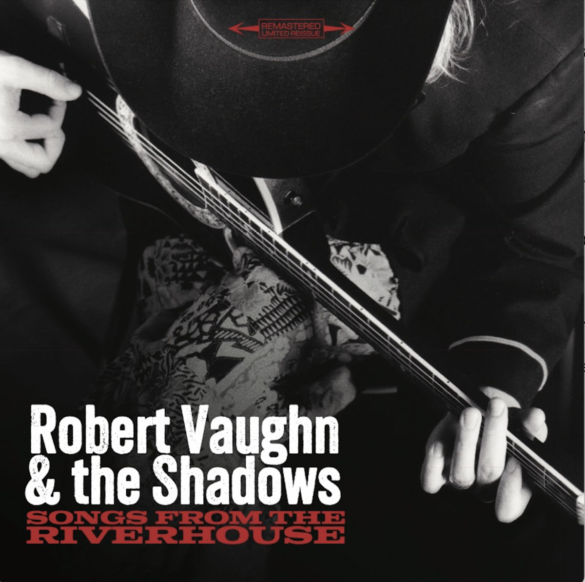 Album Art of Robert Vaughn and The Shadows's Songs From The Riverhouse album - A black-and-white photo of a man in a black coat with a black cowboy hat on is pictured from above, showing his front and and the acoustic guitar he is holding and playing. Not much else is seen in the photo, except maybe some design of some cloth below the guitar. Printed in the bottom left corner is the band name and below it the album title in smaller red letters.</body></html>