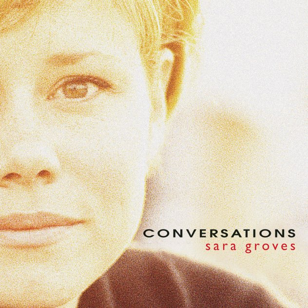 Album Art of Sara Groves's Conversations album - A close-up, grainy photo of the right side of this white woman's face from the front. Her nose and most of her mouth is on the left side of the frame, and her ear in the middle of the photo, so her face takes up most of the left half of the photo. It's just very bright behind her face and over her shoulder, which is just visible at the bottom. Printed in uppercase black letters to the right of her face is the album title, and in a bright red is the artist's name in lowercase.